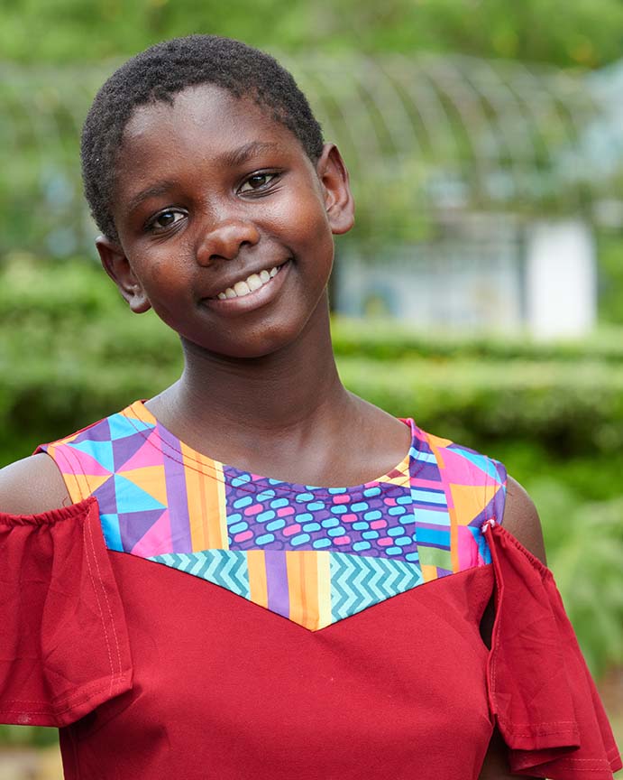 A smiling girl at Brittney’s Home of Grace representing healing, home, and a future.