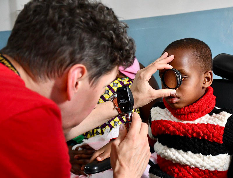A medical professional performing an eye exam at Kenya Relief.