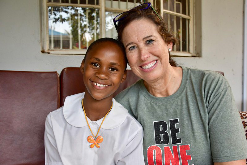 Kenya Relief staff and student smiling together at the Migori campus.