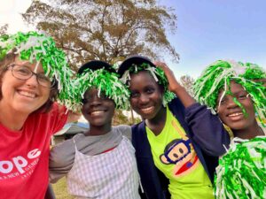 A group of happy Kenyan children benefiting from youth services and family support programs, fostering thriving futures and education.