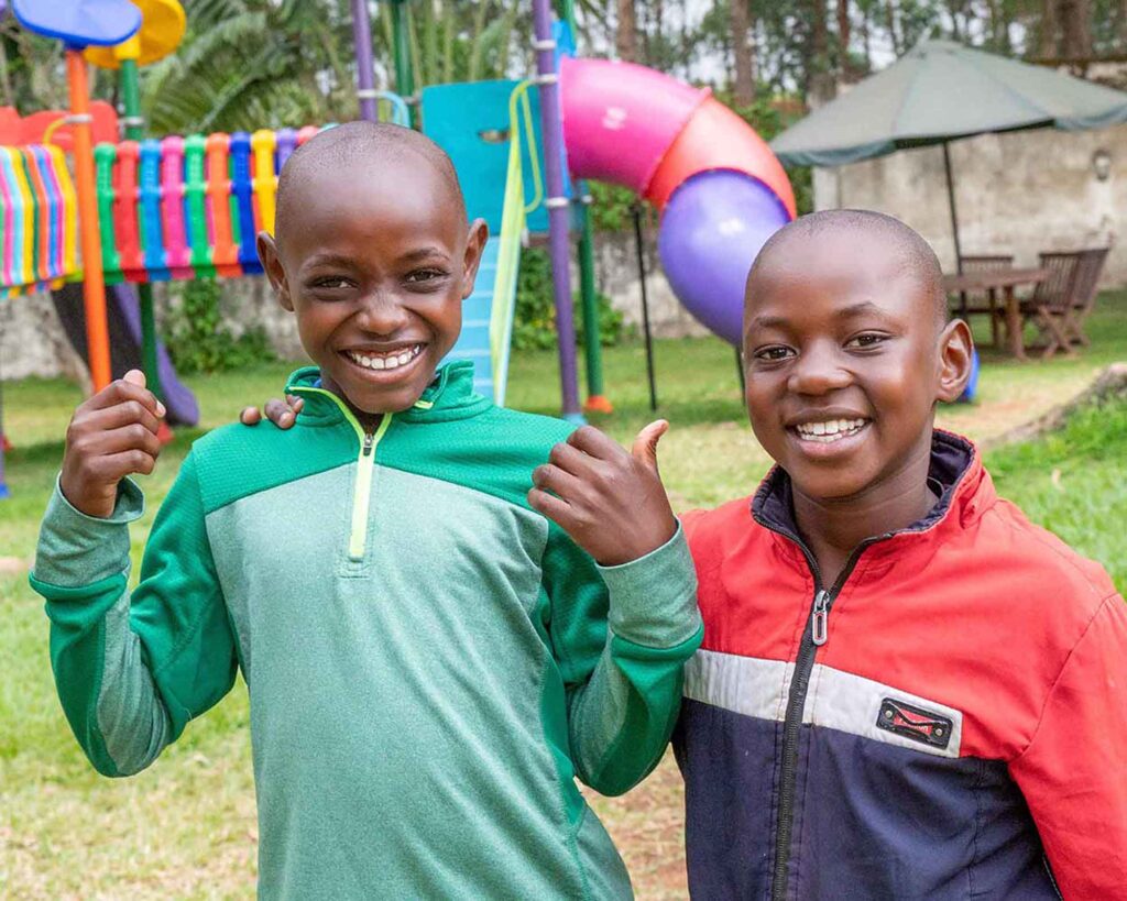 Two smiling boys giving a thumbs up at Kenya Relief, representing hope and opportunity in Migori.