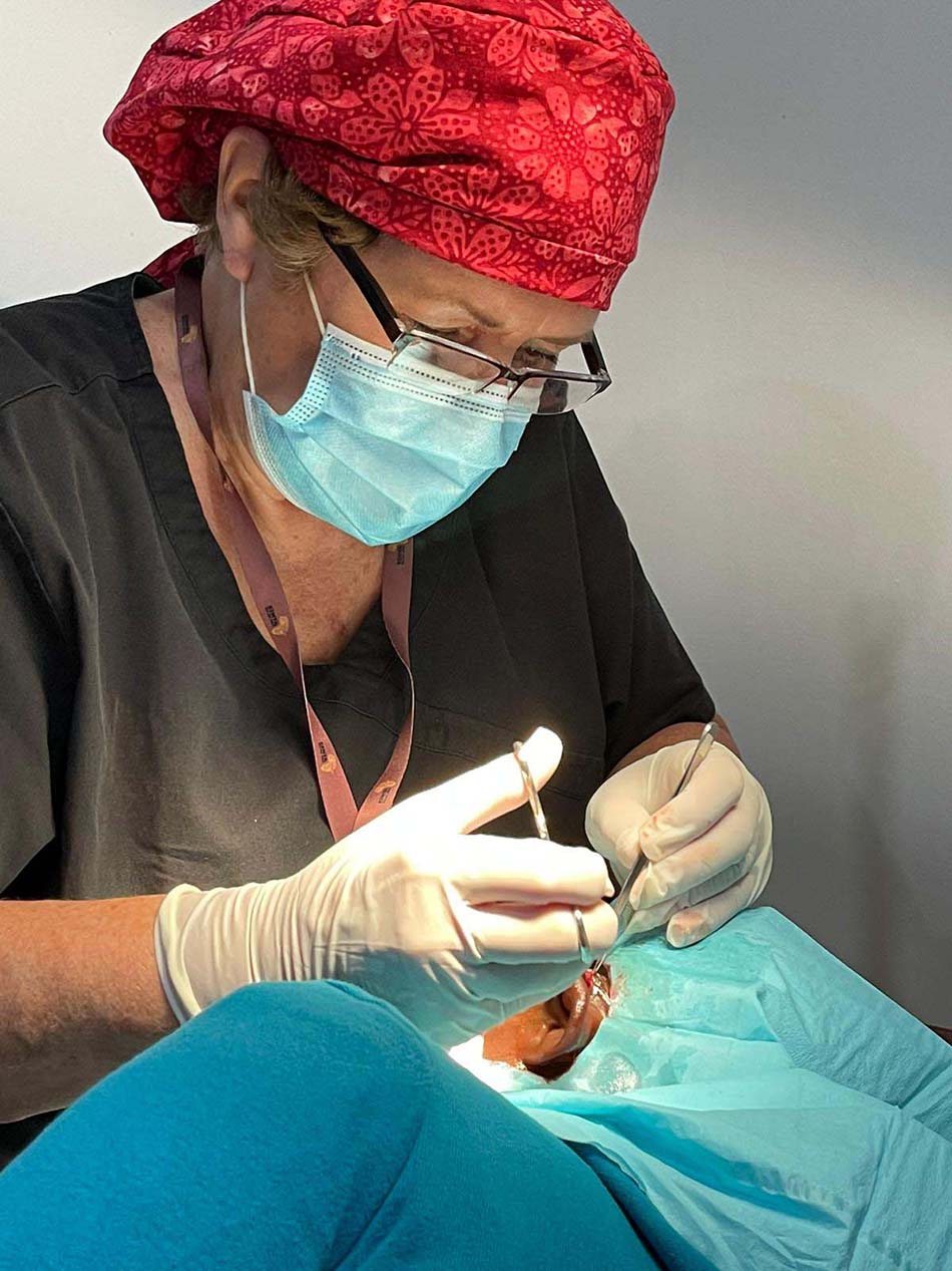Medical volunteer performing a specialized surgical procedure at the Brase Clinic and Vision Center.